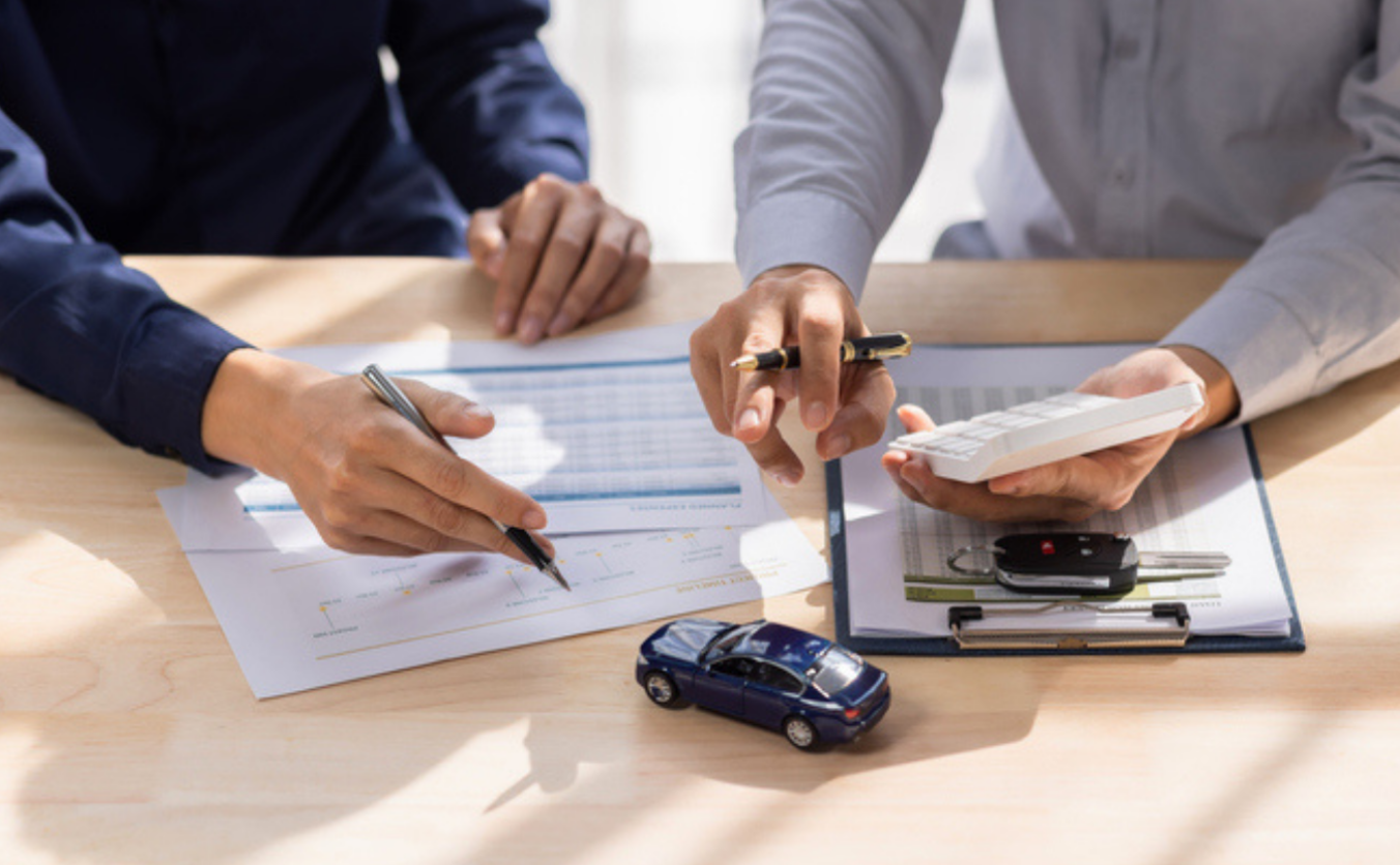 a smiling family standing in front of their new car, symbolizing the comprehensive and reliable auto insurance coverage provided by Insurance Company Grove City, LLC.