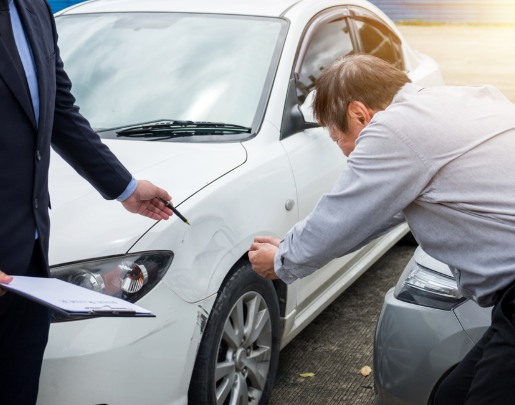 A Grove City Insurance Company customer service representative discusses auto insurance options with a client.