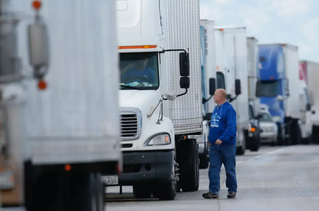 a fleet of commercial trucks, emphasizing the importance of comprehensive trucking insurance coverage offered by Insurance Company Grove City.