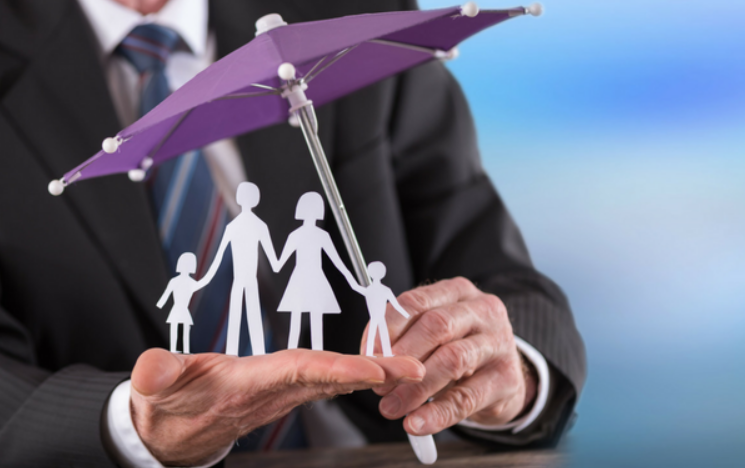 a couple standing under an umbrella, symbolizing protection and security, to represent the comprehensive coverage offered by Insurance Company Grove City through their umbrella insurance policies.