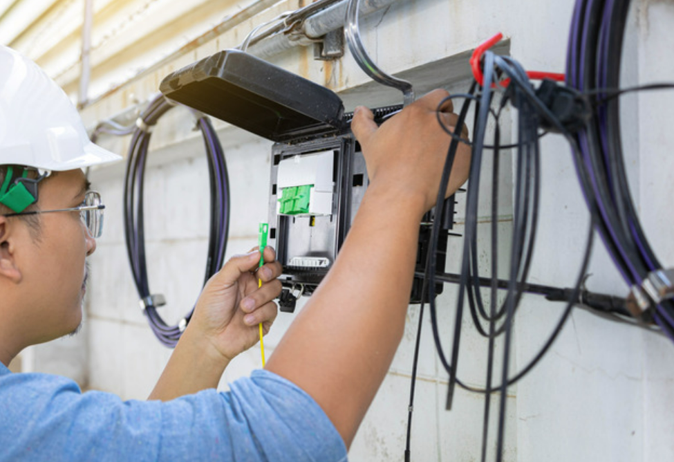 Alt Text: "Illustration of cable installation professionals covered by general liability insurance provided by Insurance Company Grove City"